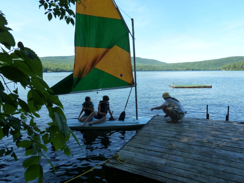 Our dock, raft, and sailboat being well enjoyed